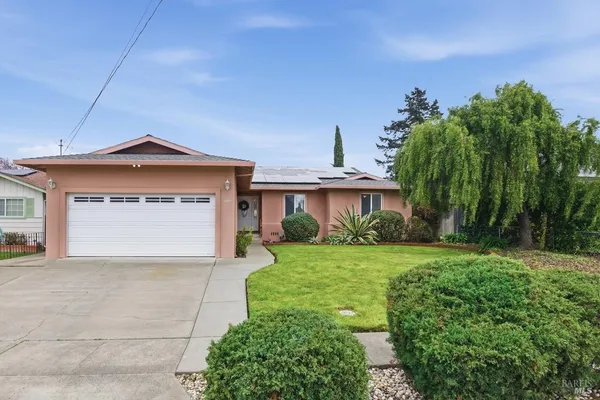 a front view of a house with a yard and garage
