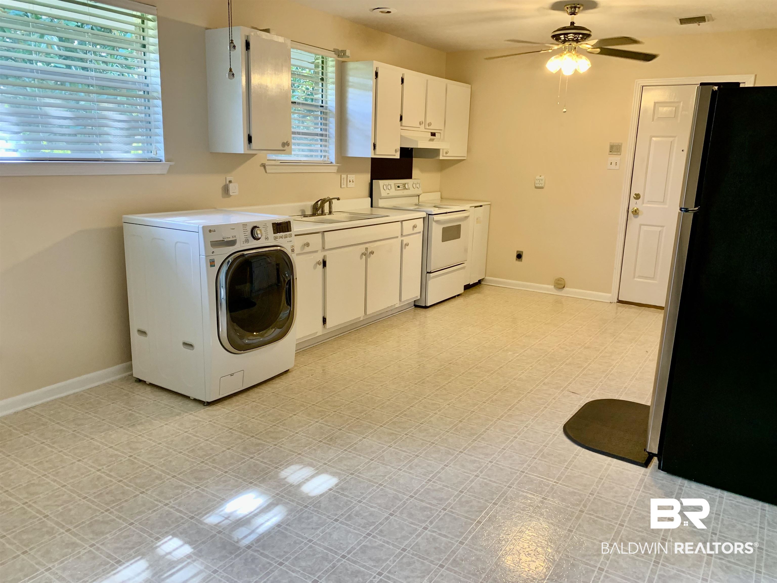 2710 West Road Mobile, AL 36693 - Photo 3 of 10 Clothes washing area featuring washer / dryer, sink, light tile patterned floors, and ceiling fan