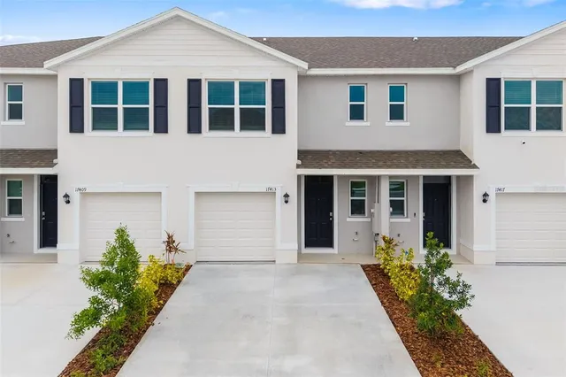 a front view of a house with a yard and garage