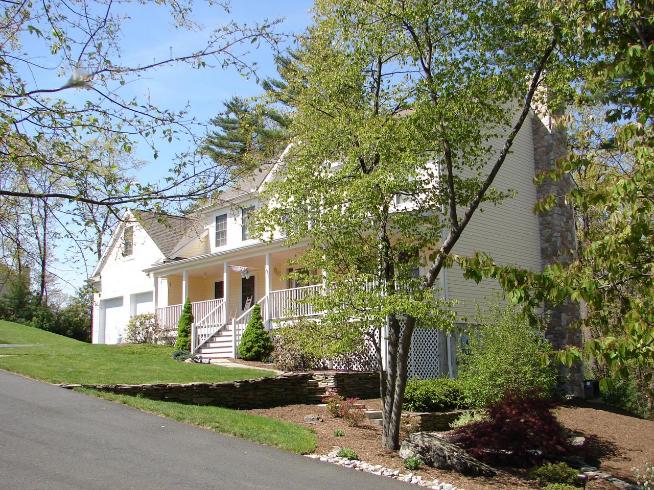 102 Kelly Road Stroudsburg, PA 18360 - Photo 10 of 13 a front view of a house with a garden
