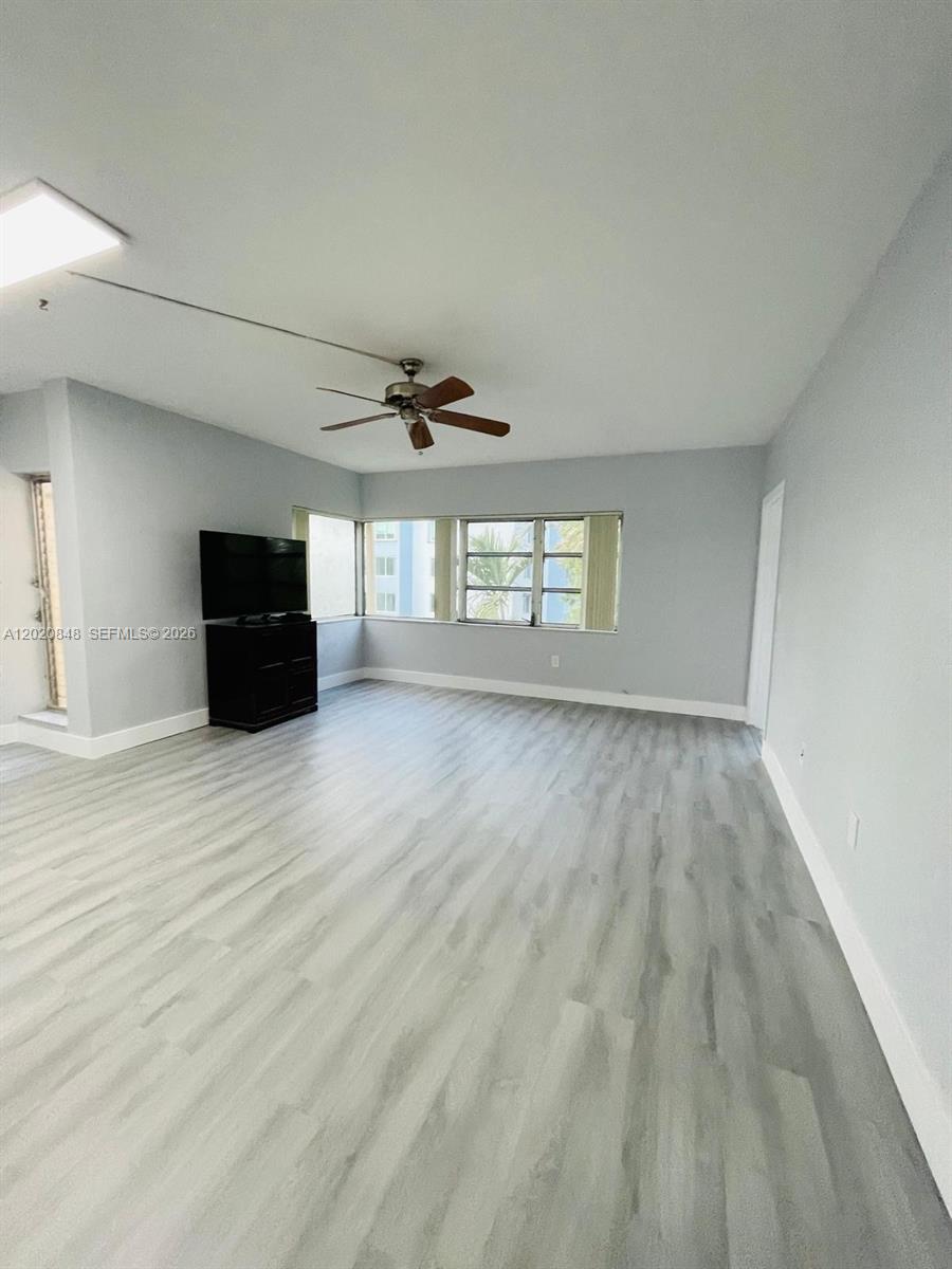 9175 Southwest 77th Avenue, Unit 306 Miami, FL 33156 - Photo 2 of 16 wooden floor in an empty room with a window