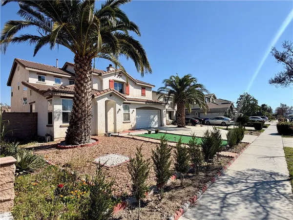 a view of a house with a small yard and plants