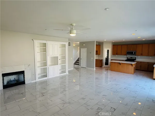 an empty room with a chandelier fan