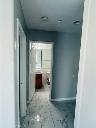 a view of staircase with lots of frames on wall and a window