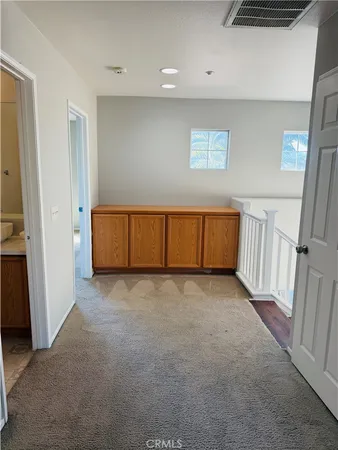 a view of a big room with closet and a chandelier fan