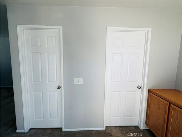 a view of a room with a ceiling fan and a window