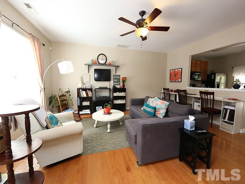 8208 Clasara Circle Raleigh, NC 27613 - Photo 2 of 19 a living room with furniture and a kitchen area