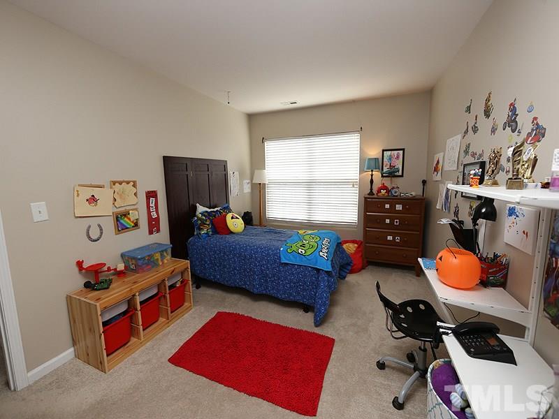 8208 Clasara Circle Raleigh, NC 27613 - Photo 12 of 19 a bedroom with furniture and a window