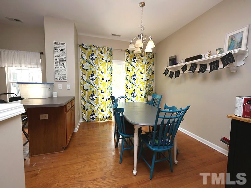 8208 Clasara Circle Raleigh, NC 27613 - Photo 7 of 19 a view of a dining room with furniture and chandelier
