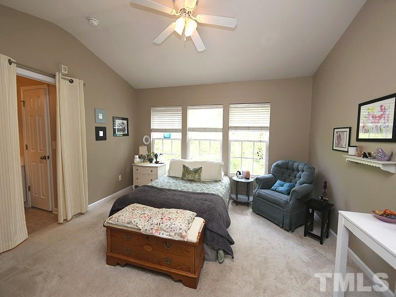 8208 Clasara Circle Raleigh, NC 27613 - Photo 8 of 19 a bedroom with a bed couches and windows