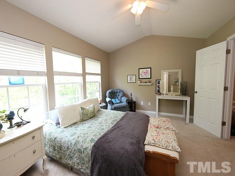 8208 Clasara Circle Raleigh, NC 27613 - Photo 9 of 19 a bedroom with a bed and a chandelier