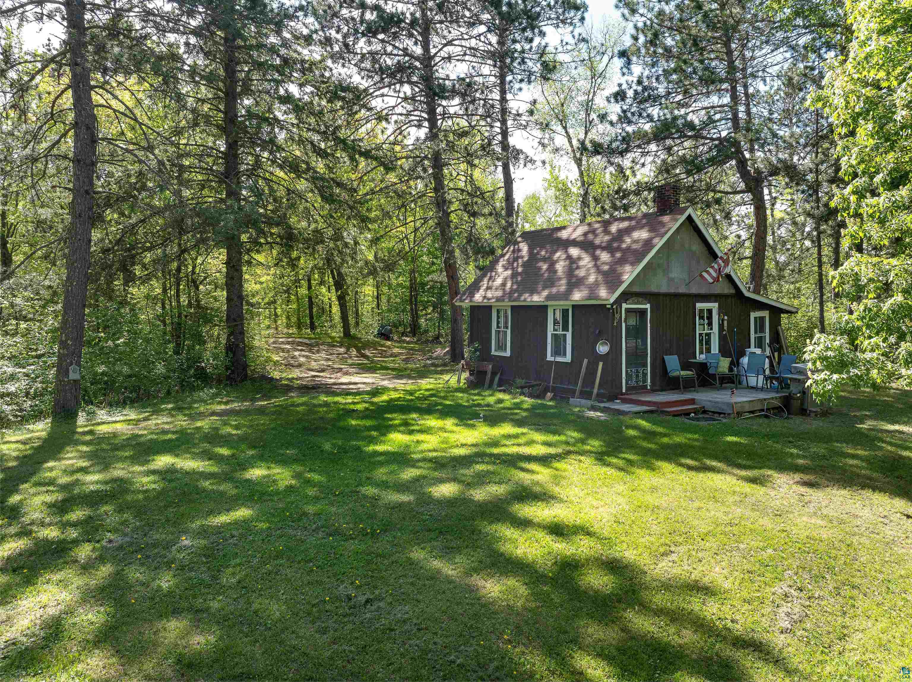 9064 Peppard Road Britt, MN 55710 - Photo 20 of 40 Wood-sided residence with white trim windows and a brown shingle roof