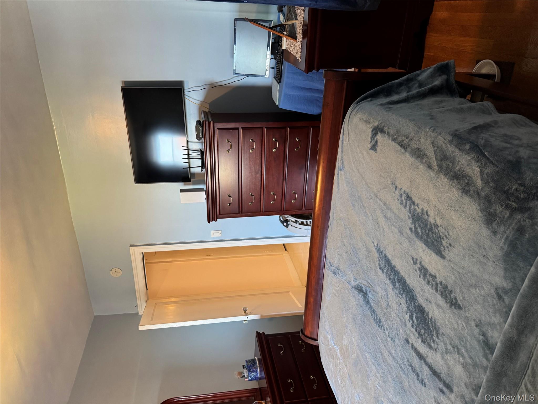 2922 Barnes Avenue, Unit 6D Bronx, NY 10467 - Photo 11 of 19 a bedroom with a bed and flat screen tv