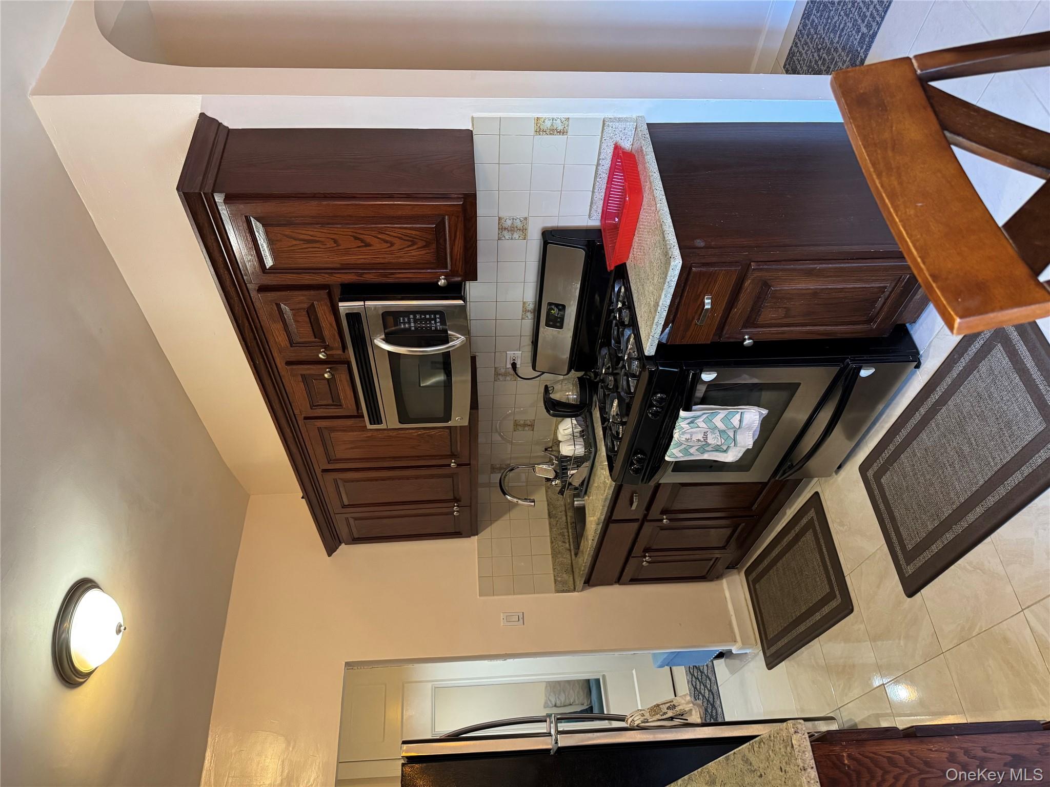 2922 Barnes Avenue, Unit 6D Bronx, NY 10467 - Photo 2 of 19 a kitchen with stainless steel appliances granite countertop a stove a microwave and a refrigerator