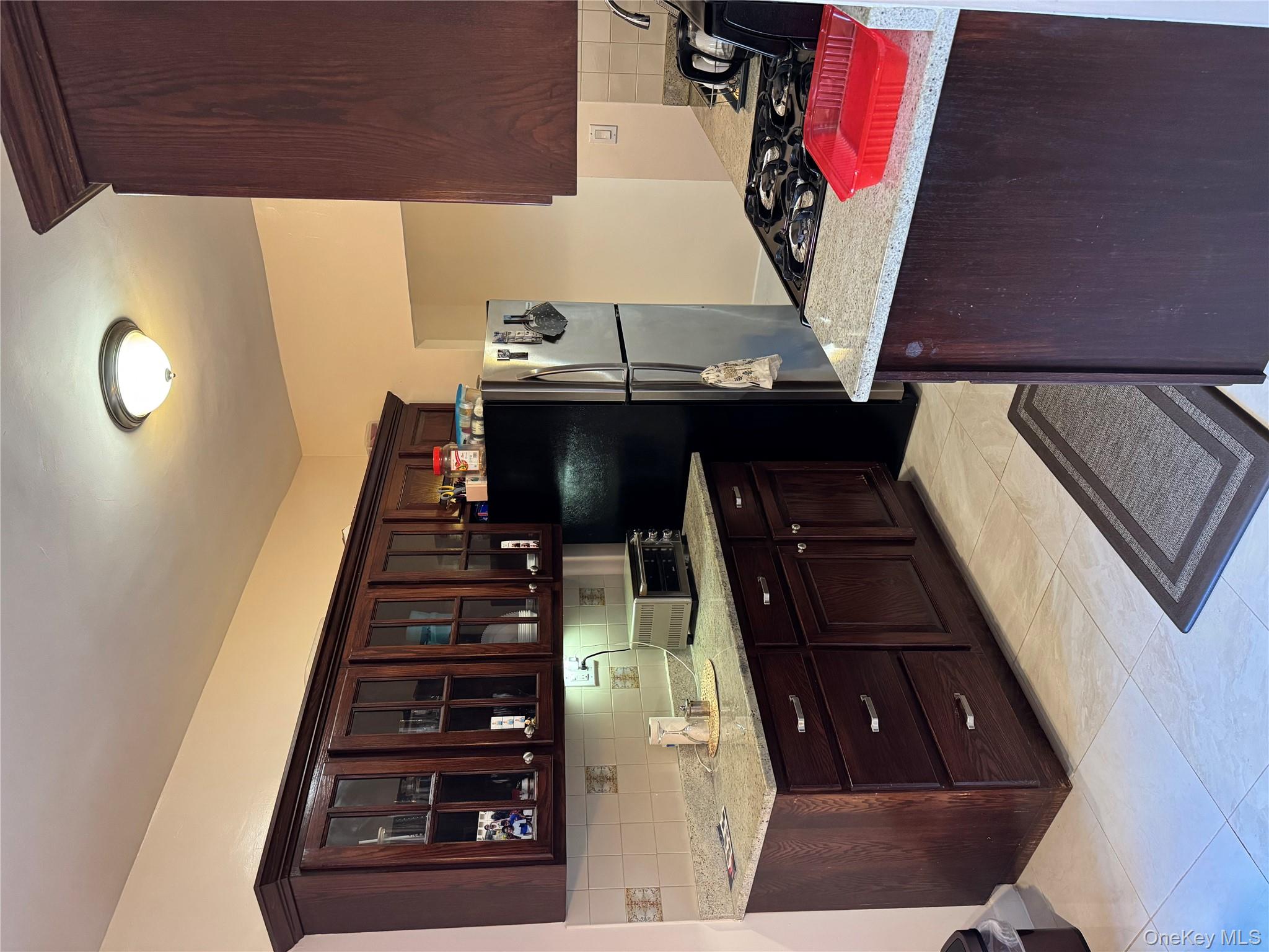 2922 Barnes Avenue, Unit 6D Bronx, NY 10467 - Photo 3 of 19 a kitchen with a refrigerator and a wooden cabinets