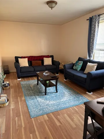 a living room with furniture and a rug