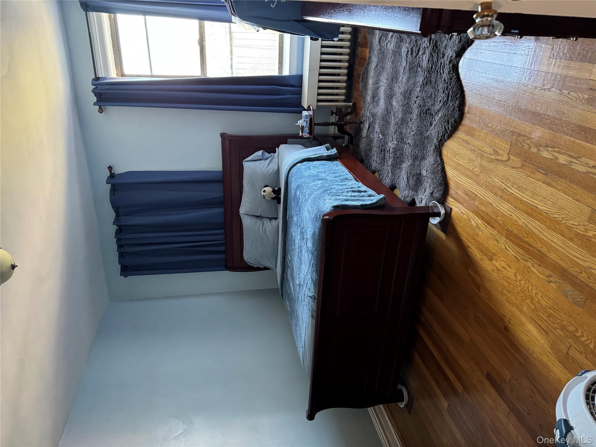 2922 Barnes Avenue, Unit 6D Bronx, NY 10467 - Photo 9 of 19 a bedroom with a bed and a window