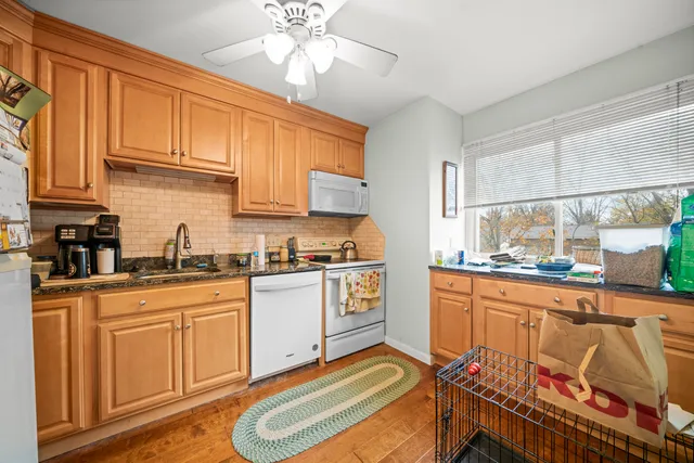 a kitchen with stainless steel appliances granite countertop a sink and cabinets