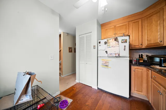a kitchen with stainless steel appliances granite countertop a refrigerator and a stove top oven