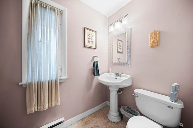 a bathroom with a sink a toilet and mirror