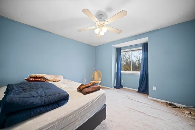 a bedroom with a bed and window