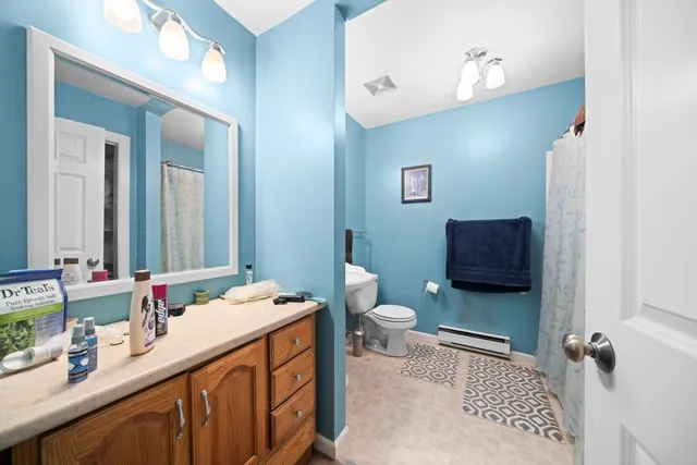 a bathroom with a sink a toilet and a mirror