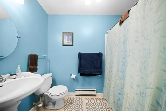 a bathroom with a toilet and a sink