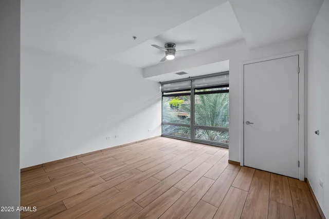 wooden floor in an empty room with a window