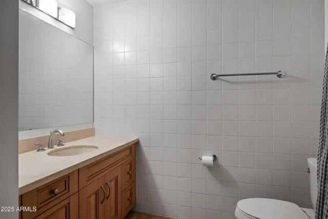 a bathroom with a sink toilet and a mirror