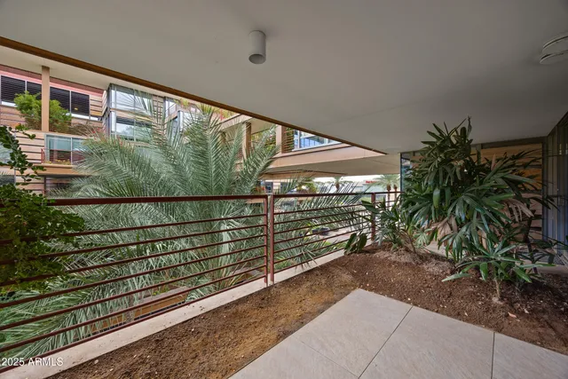 a view of a balcony with a tree