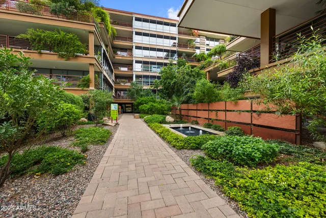a view of a garden with a building in the background