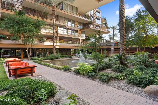 a backyard of a building with barbeque oven and outdoor seating