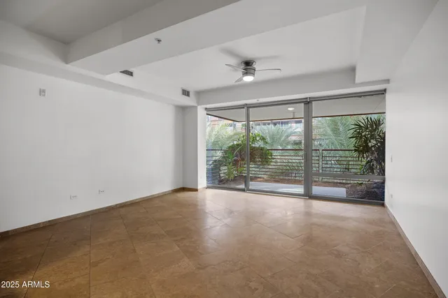 an empty room with large windows