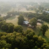 a front view of a house with garden and sitting area