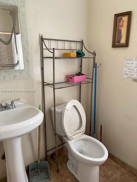 829 Southwest 19th Avenue Miami, FL 33135 - Photo 26 of 30 a bathroom with a toilet sink and mirror