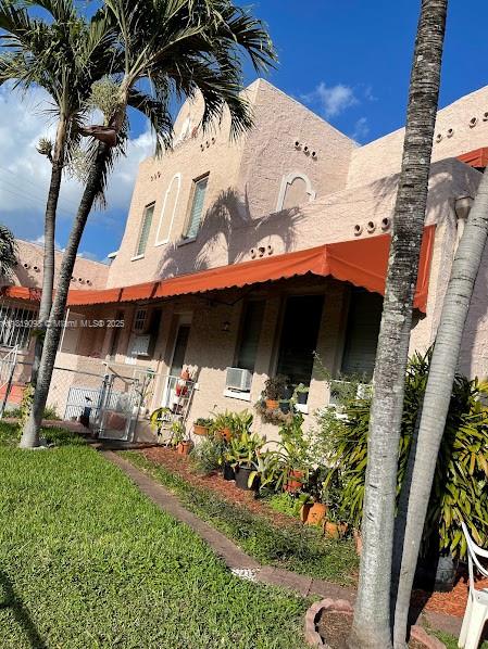 829 Southwest 19th Avenue Miami, FL 33135 - Photo 3 of 30 a front view of a house with a yard and garage