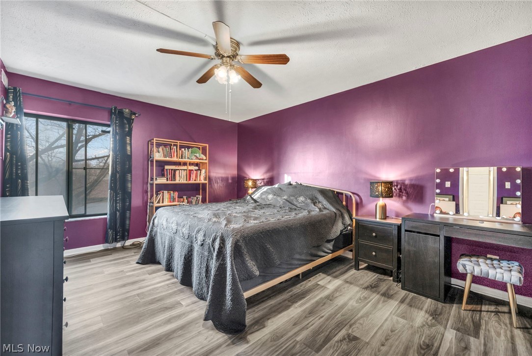 22952 Mastick Road, Unit 203 Cleveland, OH 44126 - Photo 18 of 35 Bedroom featuring light hardwood / wood-style flooring, a textured ceiling, and ceiling fan