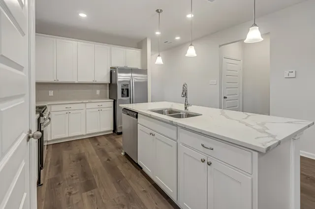 a bathroom with a sink a vanity and a large mirror