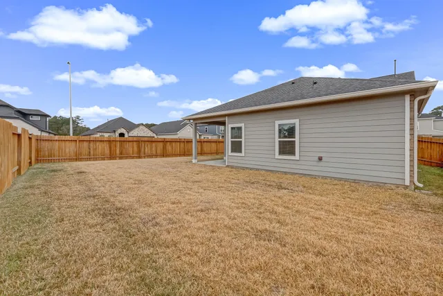 a view of a house with a backyard