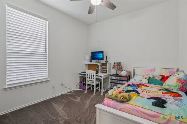 a bedroom with furniture and a flat screen tv