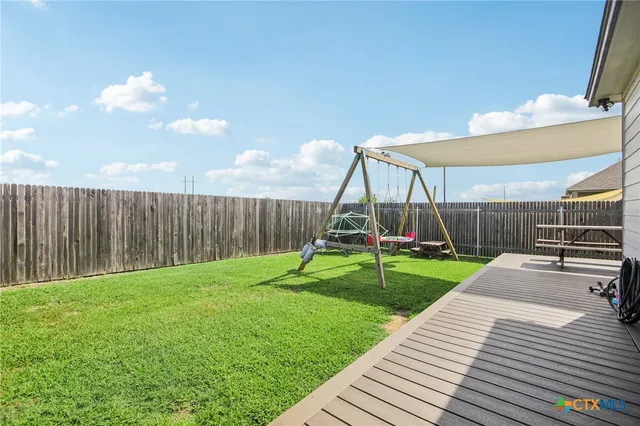 a view of a house with a yard and sitting area