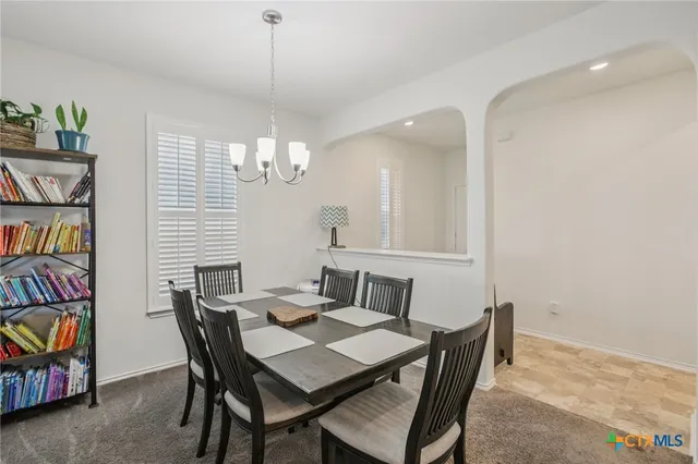 a kitchen with stainless steel appliances granite countertop a stove top oven a sink and a refrigerator