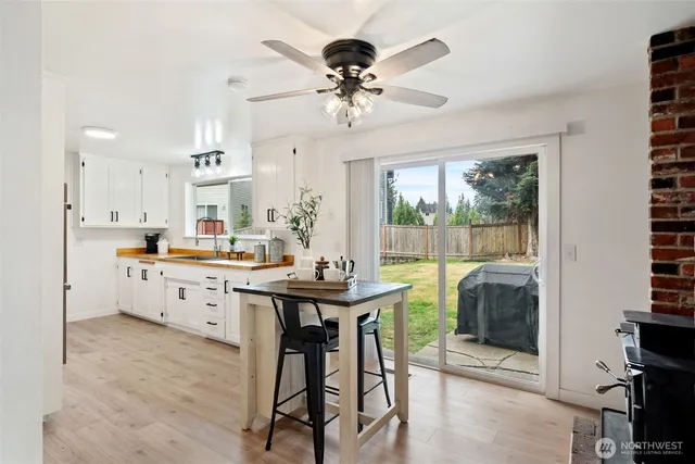 a view of a dining room with furniture a chandelier and wooden floor