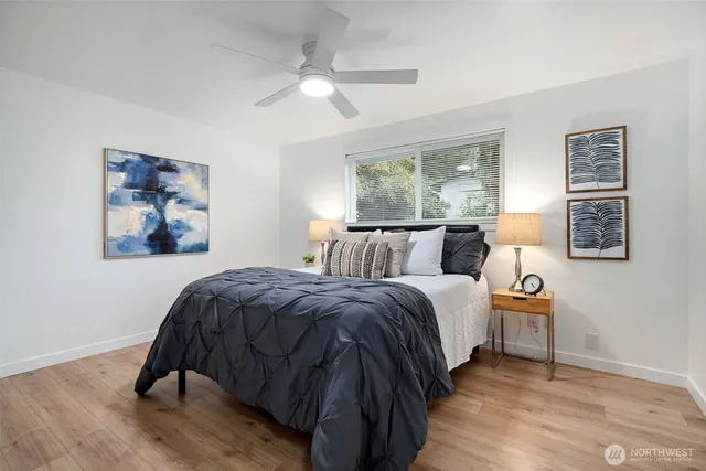 a bedroom with a bed and wooden floor