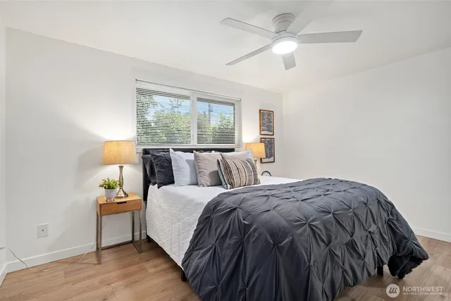 a bed sitting in a bedroom next to a window