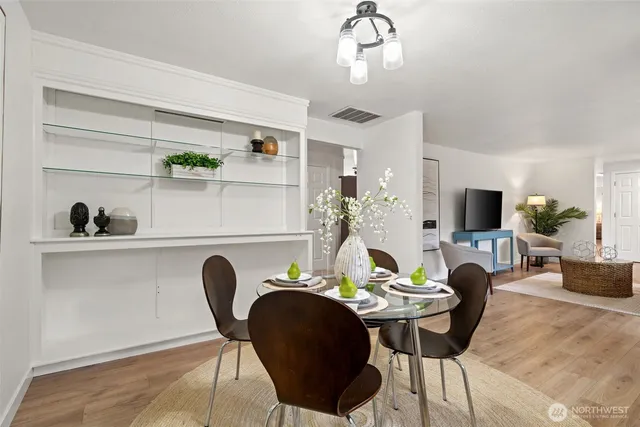 a view of a dining room with furniture and wooden floor