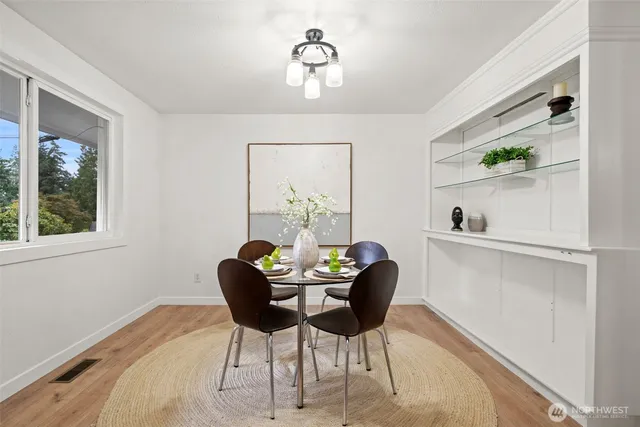 a dining room with furniture and window