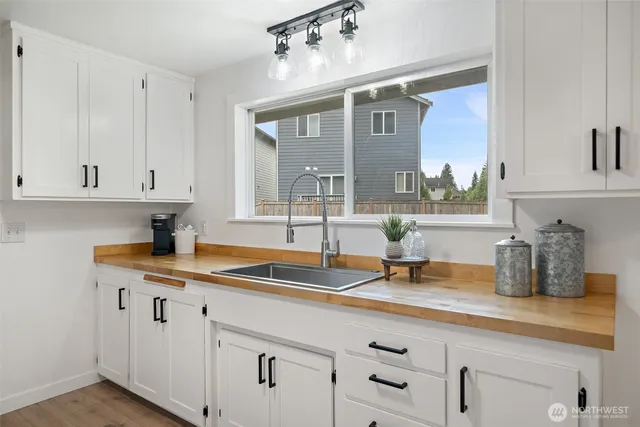 a kitchen with a sink and cabinets