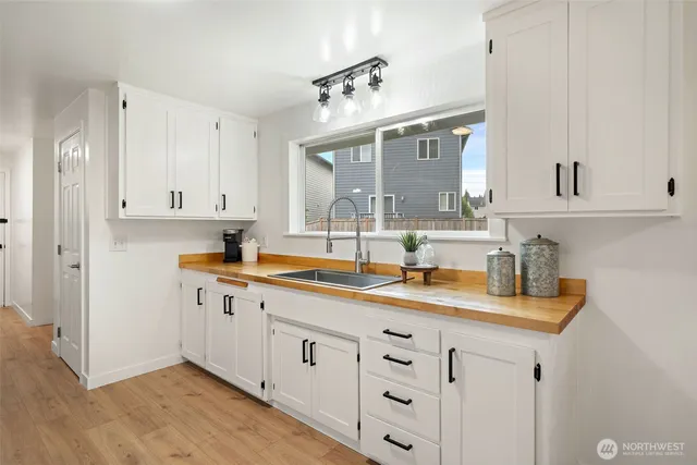 a spacious bathroom with double sink and a mirror