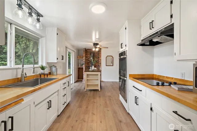 a kitchen with cabinets and window